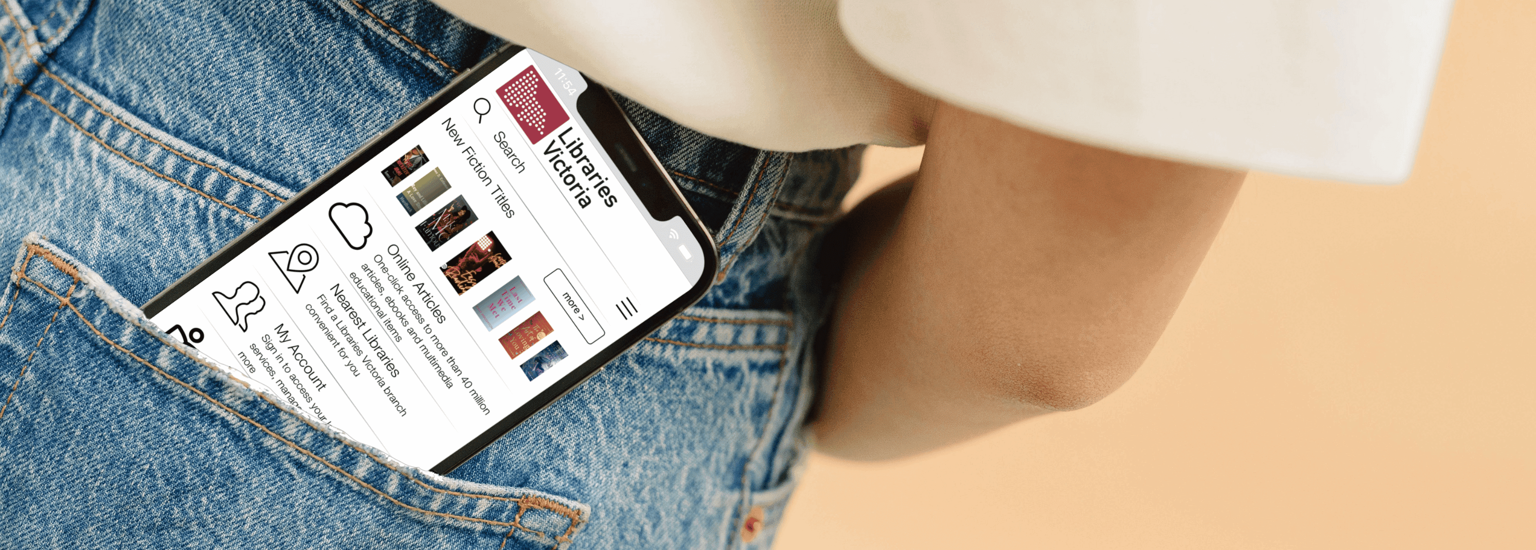 There is a smartphone in sitting slightly out of the back pocket of a person's blue jeans. The screen of the phone shows the home page of the Libraries Victoria app.