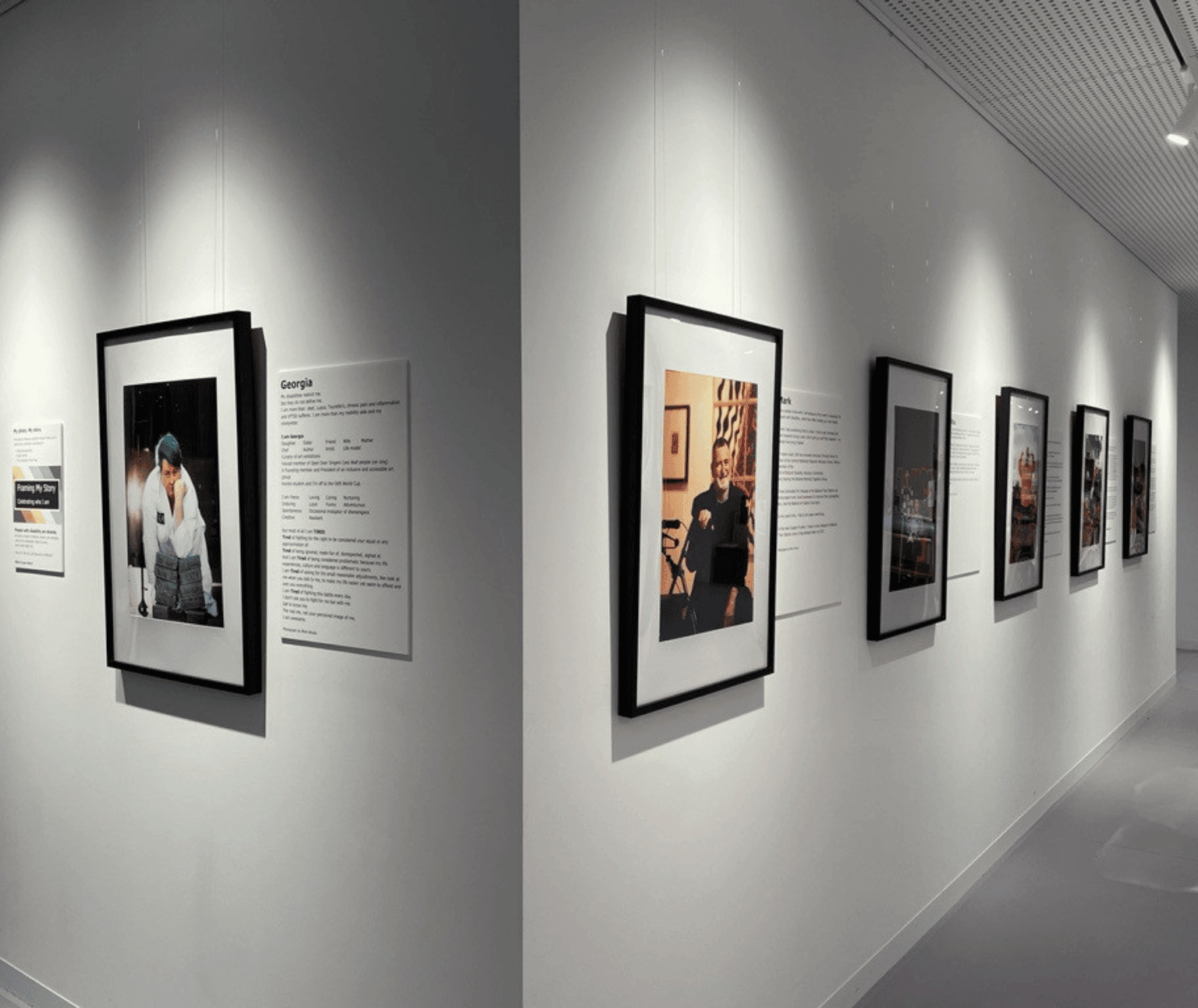 A photo of the framed photographs on the wall at Ballarat Library. Each is accompanied by text about the person in the photo.