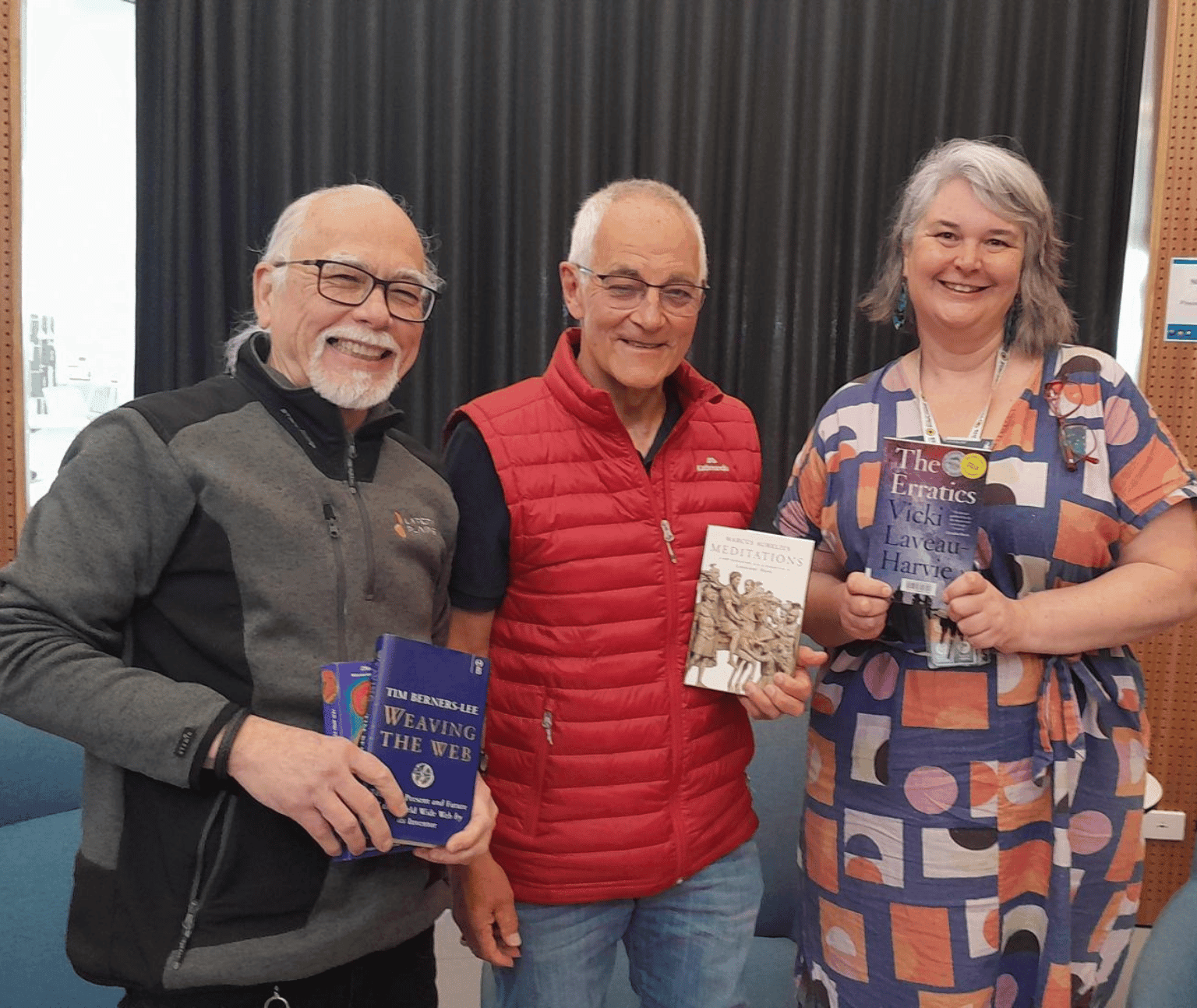 Photo of the three presenters holding books featured in the reading list.