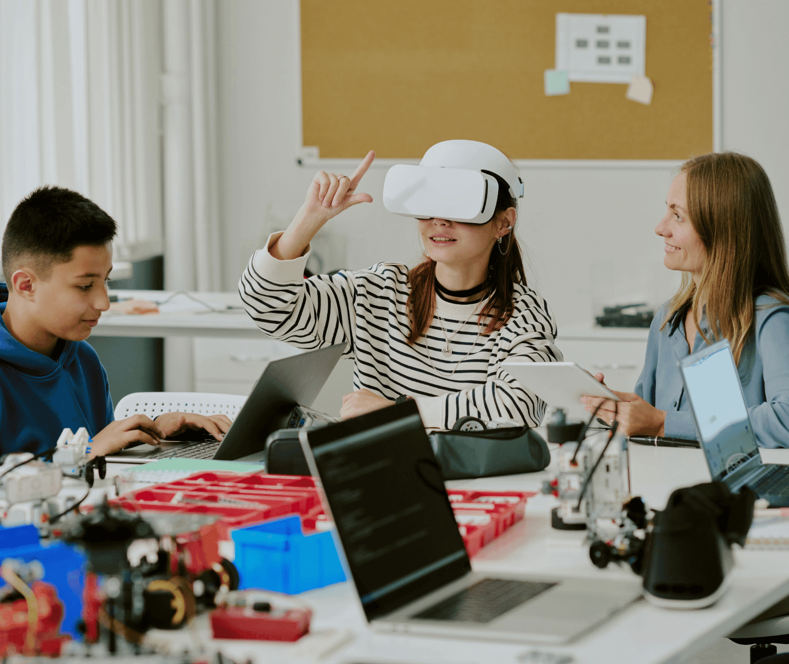 Photo of teens using VR and other technology alongside an instructor.