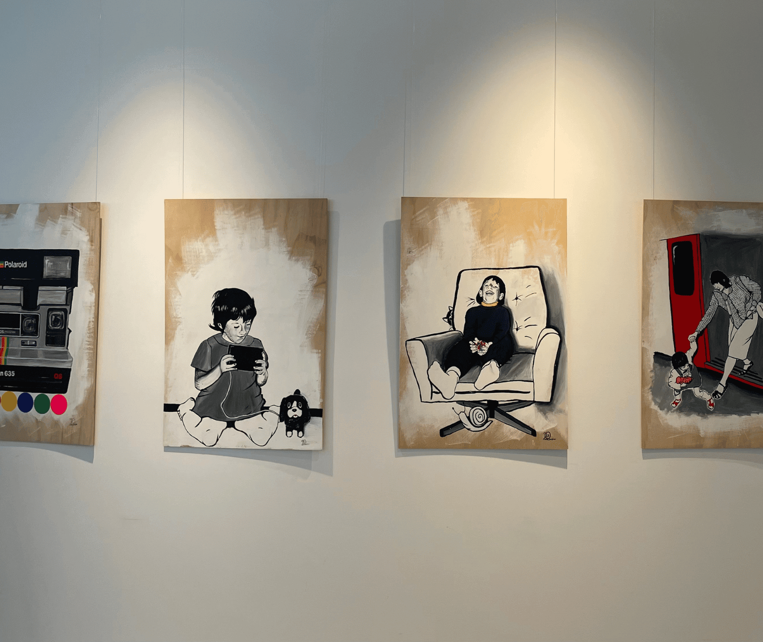 Photo of paintings from the exhibition on the wall at Ballarat Library.