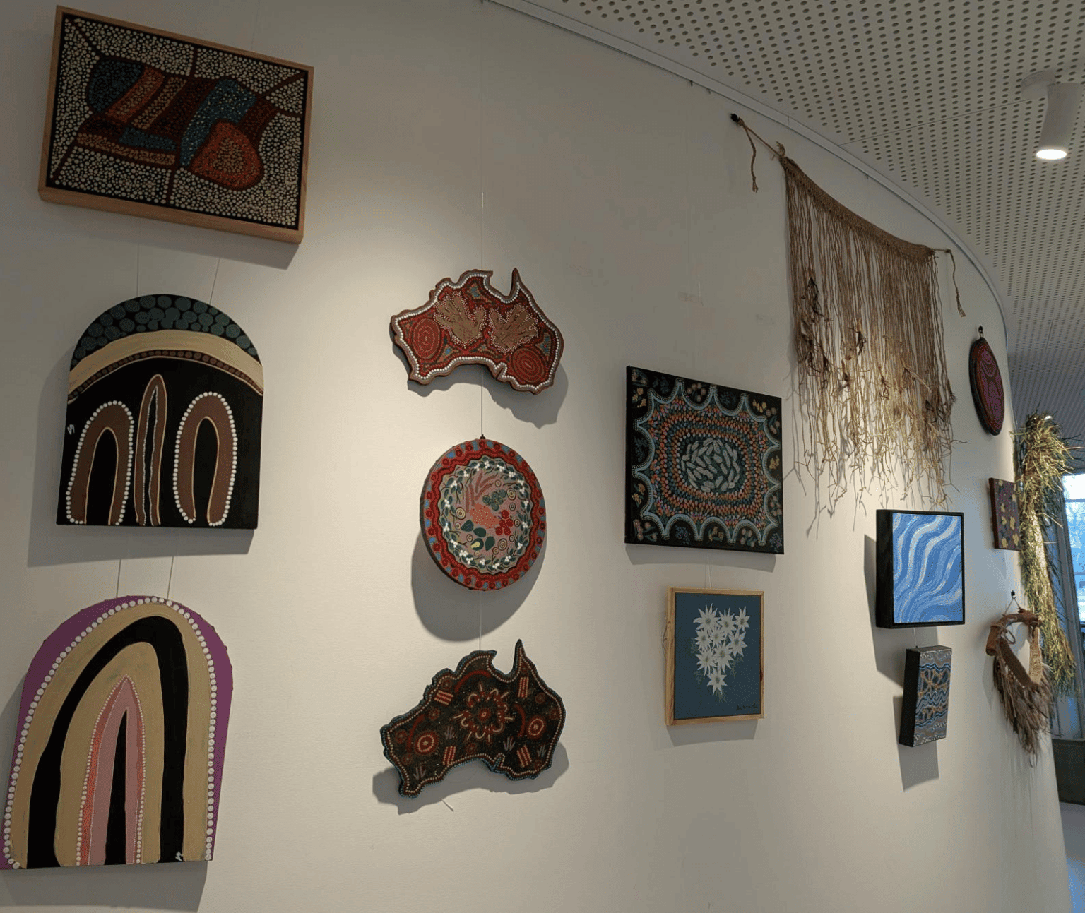 Photo of various First Nations artworks on wall at Ballarat Library.
